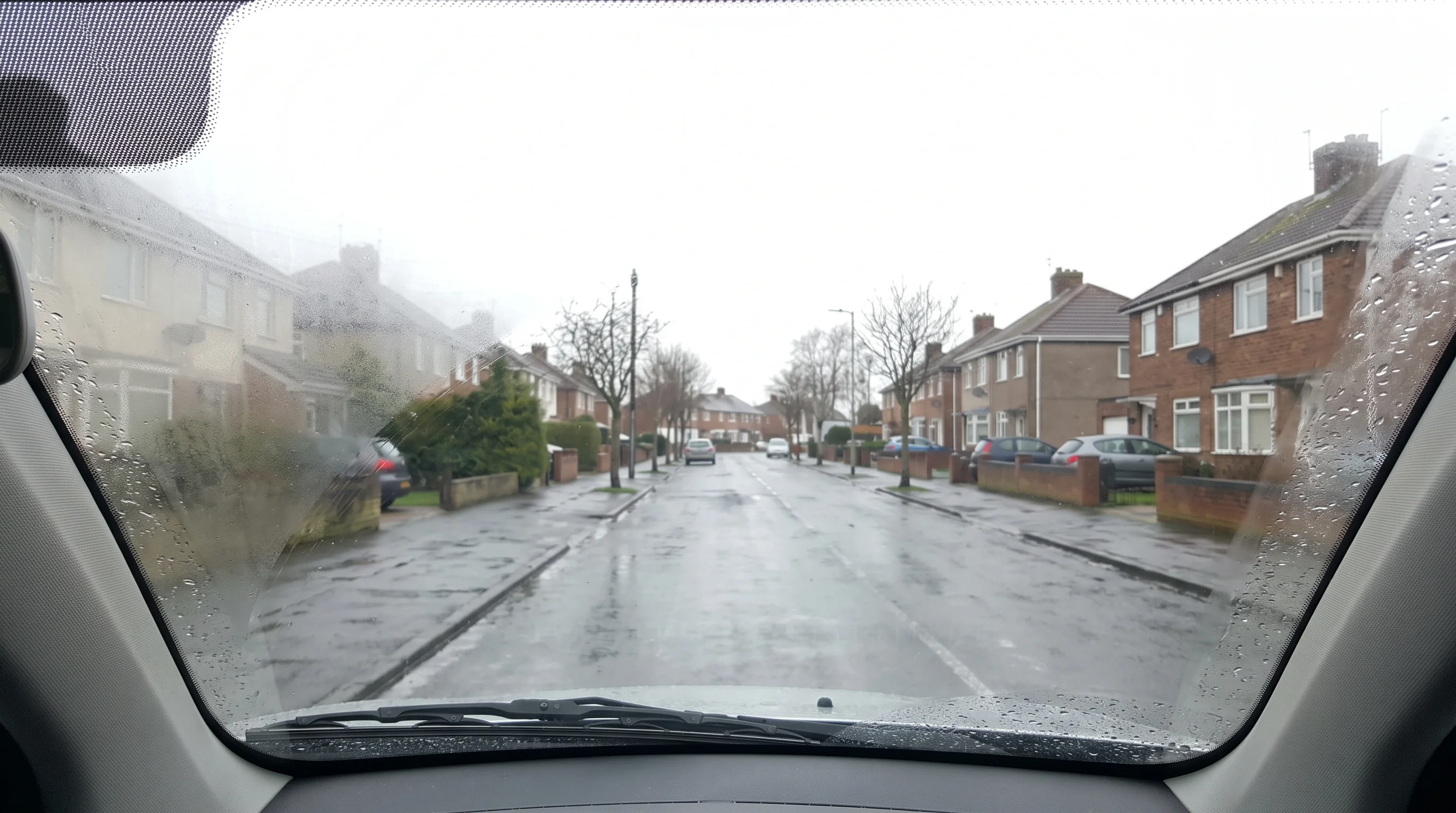 A quiet residential street in Darlington seen through a lightly misted car windscreen at the start of a lesson